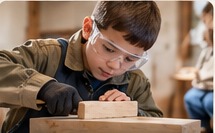 Child learning simple woodwork